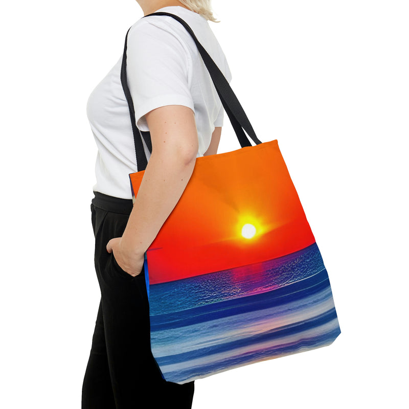The perfect Tote Bag for the beach. A beautiful sunset over the water decorates this stylish and functional tote.