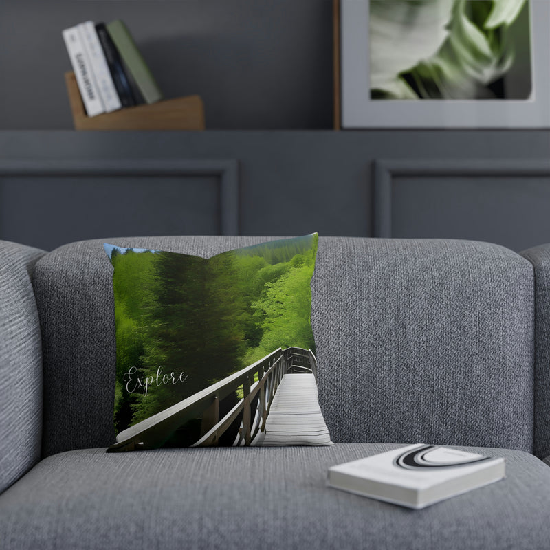From our Adventure collection of merchandise, a beautiful accent cushion showing a walking bridge surrounded by a lush green forest. Perfect addition to your cabin, vacation home or rental property. Matching coffee mug also available.