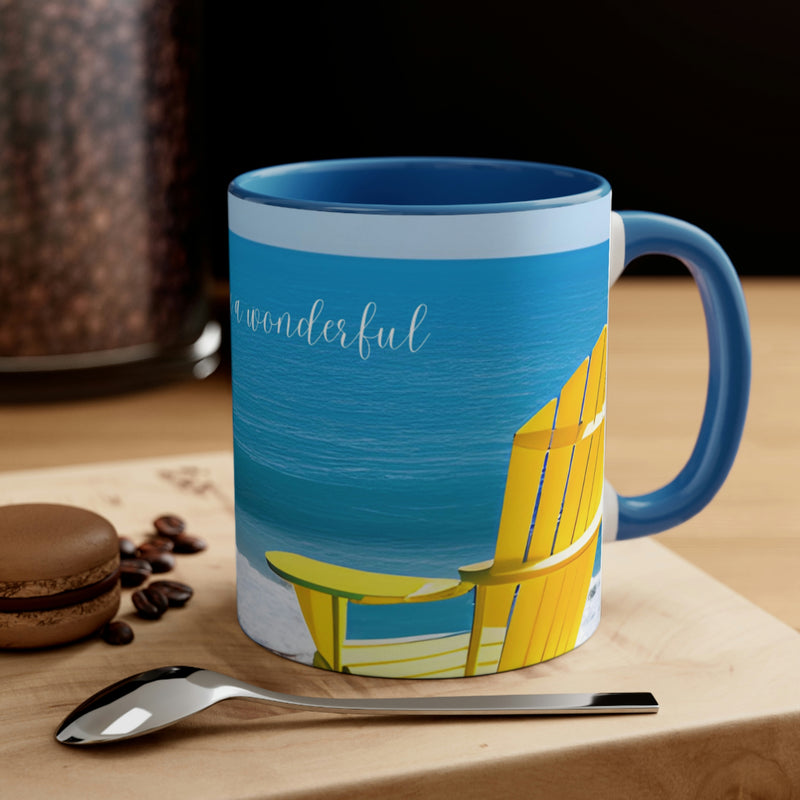 Beautiful coffee mug from our Sand and Sun collection. Bright yellow Adirondack chair surrounded by blue sky and blue water. The perfect addition to your beach house or vacation rental.